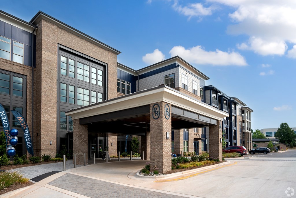 an office building with an entrance and awning on the side of a street at Preston Ridge, Cary, NC, 27513